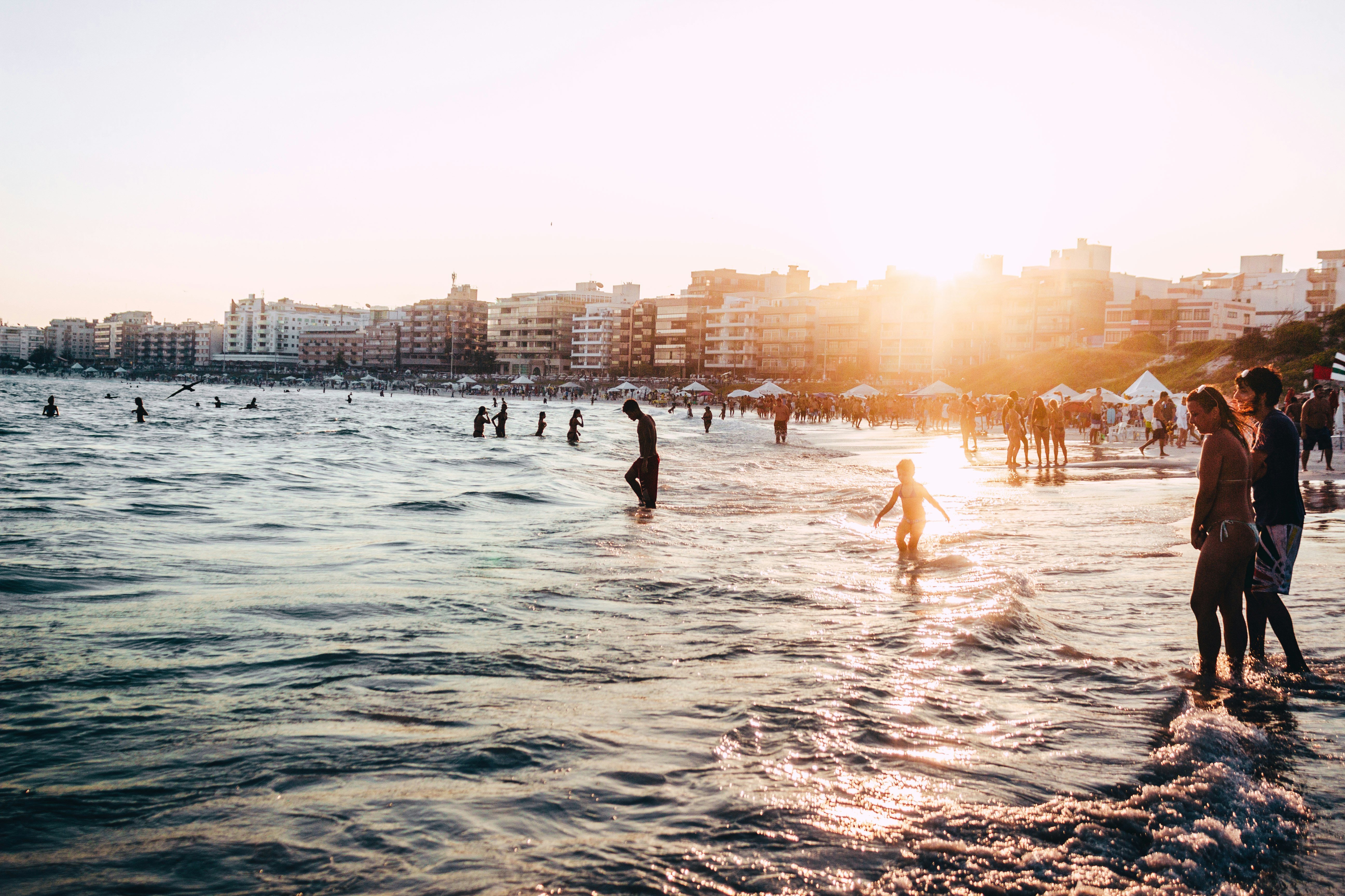 people standing near body of water at daytime